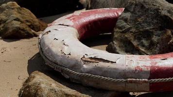 old broken Lifebuoy on sea beach photo