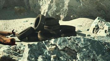 Old car tires on the beach photo