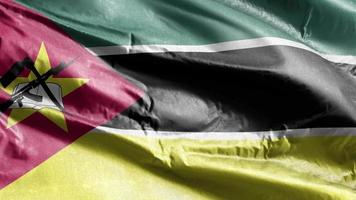 Mozambique textile flag waving on the wind loop. Mozambican banner swaying on the breeze. Fabric textile tissue. Full filling background. 10 seconds loop. video