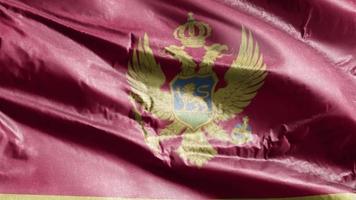 montenegro textiel vlag zwaaien op de wind-lus. montenegrijnse banner zwaaiend op de wind. stof textiel weefsel. volledige vulling achtergrond. 10 seconden lus. video