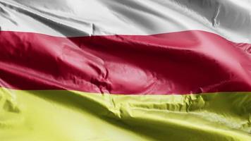 North Ossetia flag waving on the wind loop. North Ossetia banner swaying on the breeze. Full filling background. 10 seconds loop. video