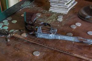 little sword pistol and coins in a room from a house photo