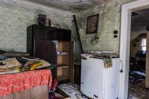 refrigerator and a wooden cabinet with picture in a room from a house photo