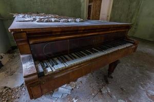 beautiful old wooden piano in a green room photo