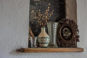 catkins in a vase and picture on a wald from a room photo