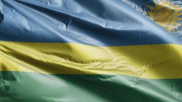 rwandas flagga vajar långsamt på vindslingan. rwandisk banderoll svajar smidigt på vinden. full fyllning bakgrund. 20 sekunders loop. video