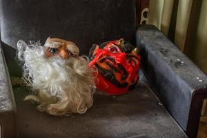 masks from saint nicholas and devil on a armchair in a house photo