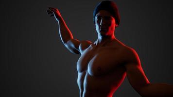 Handsome muscular shirtless young man standing in the dark photo