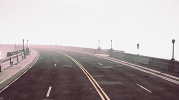 View of the bridge over the river in fog photo