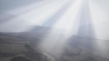 Sun Rays against the Backdrop of the Mountains photo