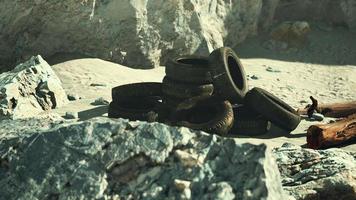 Old car tires on the beach photo