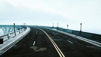 View of the bridge over the river in fog photo