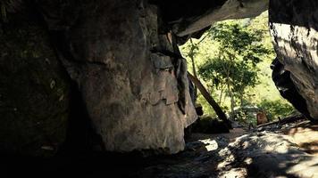 shot taken from inside a small cave looking out photo