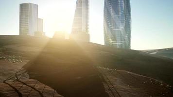 city skyscrapes in desert at sunset photo