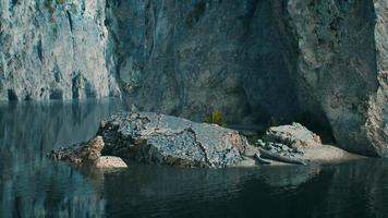 rocky cliffs in the ocean at sunny day photo