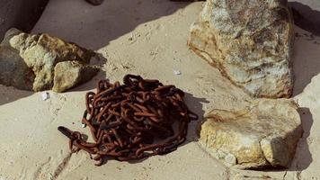 old rusted chain in the sand photo