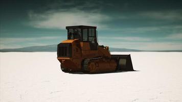 road grading machine on the salt desert road photo