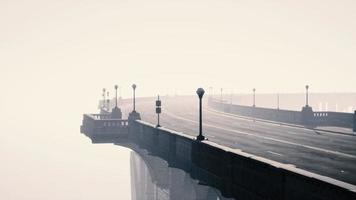 illuminated empty road bridge in a fog photo