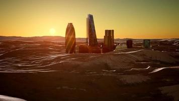 city skyscrapes in desert at sunset photo