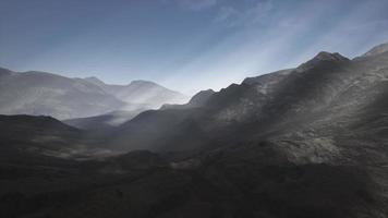 Sun Rays against the Backdrop of the Mountains photo