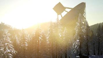 The observatory radio telescope in forest at sunset photo