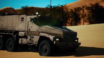 Armoured military truck in desert photo