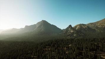 Rocky mountain range with trees photo