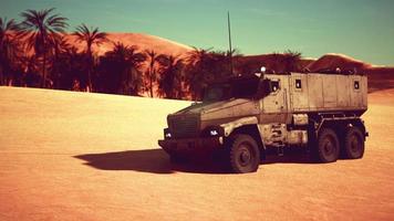 Armoured military truck in desert photo