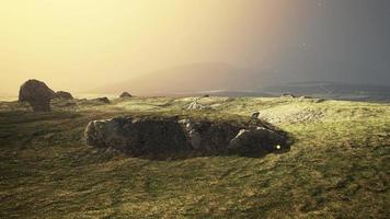 mountain landscape at sunset with tone in the foreground on the field photo