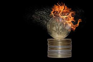 stack of many valueable burning decomposes and dissolves bitcoin from crypto currency with black photo