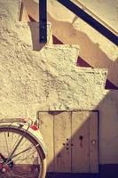 Retro wheel bicycle detail and old stairs. Vintage style. photo