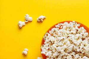Popcorn in an orange bowl. photo