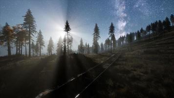 The milky way above the railway and forest photo