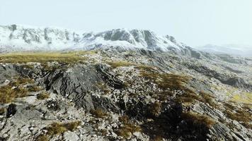 lanscape with barren mountain which is covered with ice photo