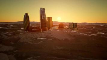 city skyscrapes in desert at sunset photo