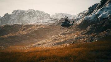 slow motion Vietnam War era helicopter in mountains photo