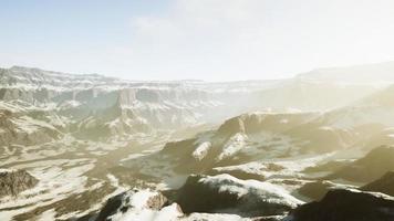 snowy mountains with deep ravine and rock cliffs