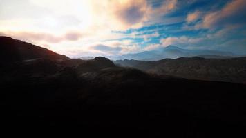 black volcanic dust and mountains with fog in background photo