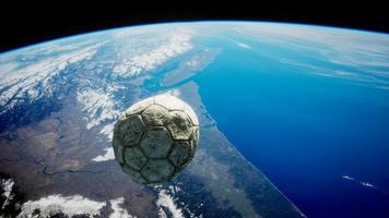 old soccer ball in space on Earth orbit video