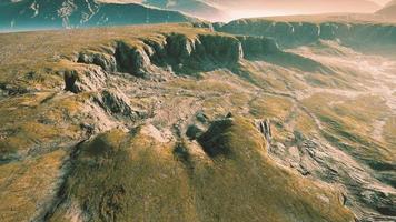 Grasslands wide panorama with autumn grass field and mountains photo