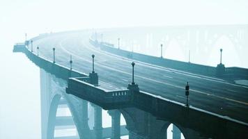 Old empty stone bridge on a foggy day photo