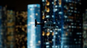 slow motion helicopter near skyscrapers at night