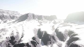 snowy mountains with deep ravine and rock cliffs video