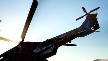 old rusted military helicopter in the desert at sunset video