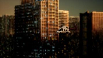 slow motion helicopter near skyscrapers at night video