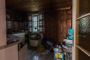 dark kitchen with many objects in a house photo