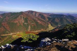 view to the valley from the summit of a mountain while hiking photo