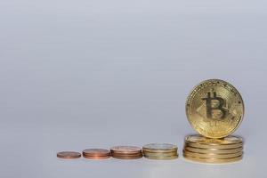 euro coins and bitcoins from crypto currency stacked in a row with gray photo