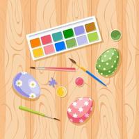 Handmade painted Easter eggs on wood background. Paints and brushes for decorating Easter eggs on wooden table, top view. Preparation for Easter Holiday vector