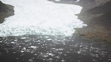 glacier flow through the mountains in Iceland photo